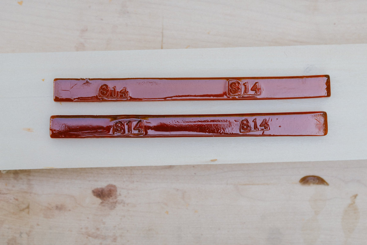 Merit #14 Amber shellac sticks, stamped, on a maple board