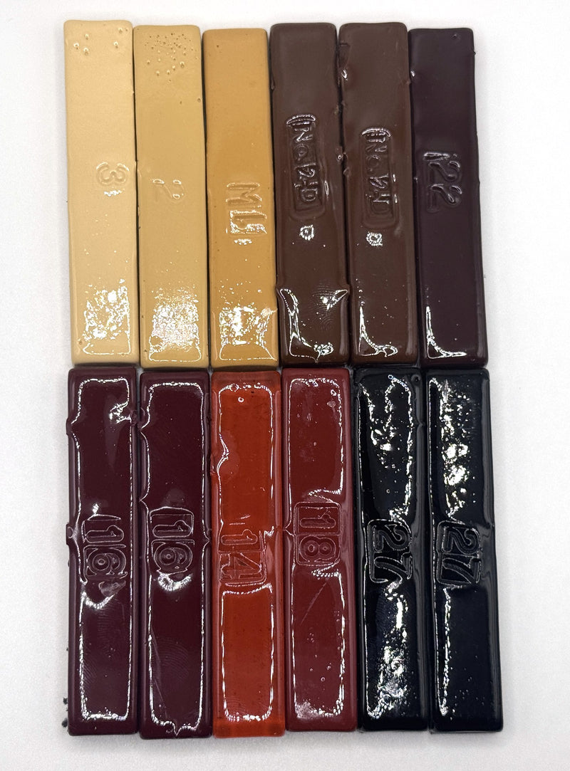 Twelve vintage half sticks, light to dark