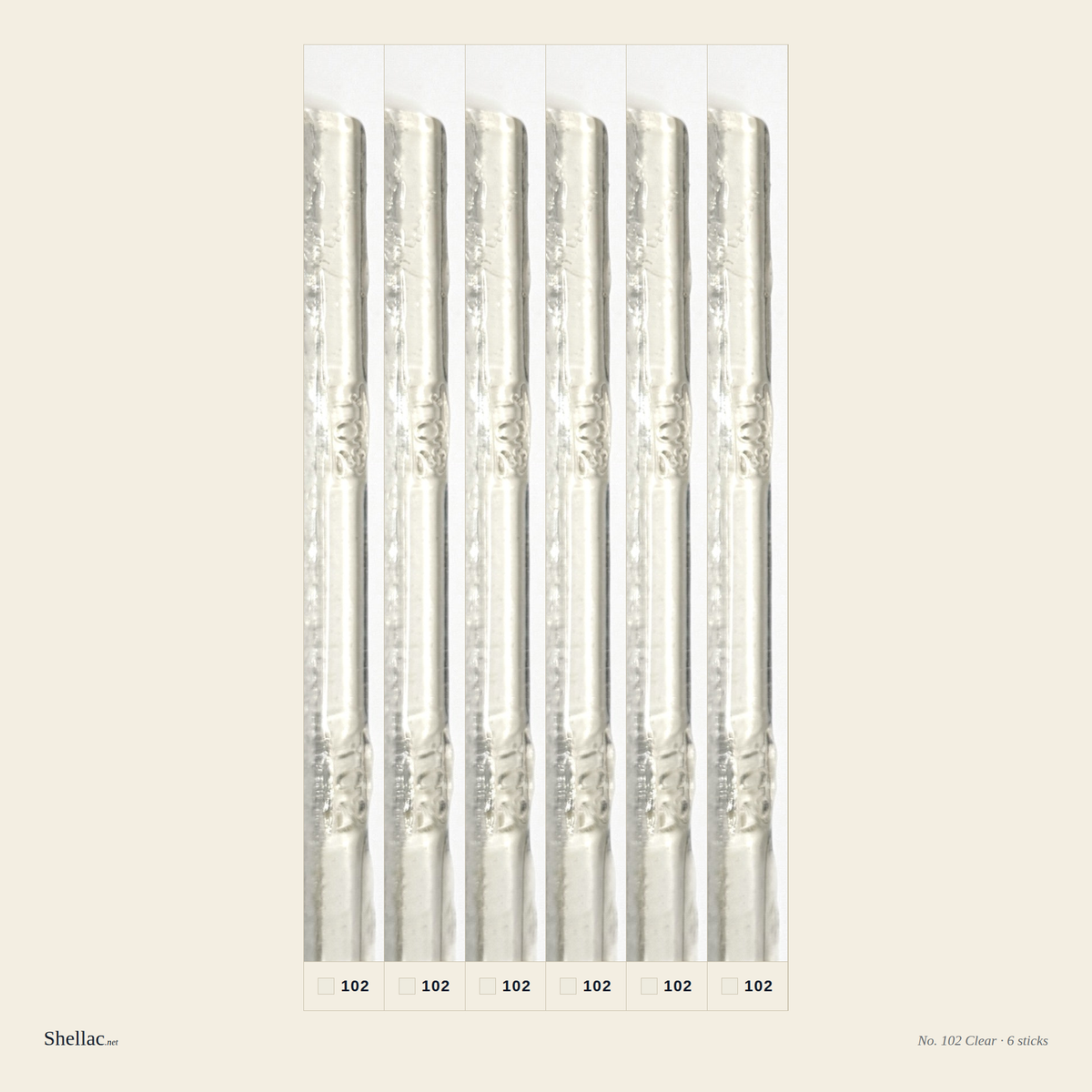 Six Merit No. 102 Clear burn-in sticks side by side — water-clear resin, embossed color number visible