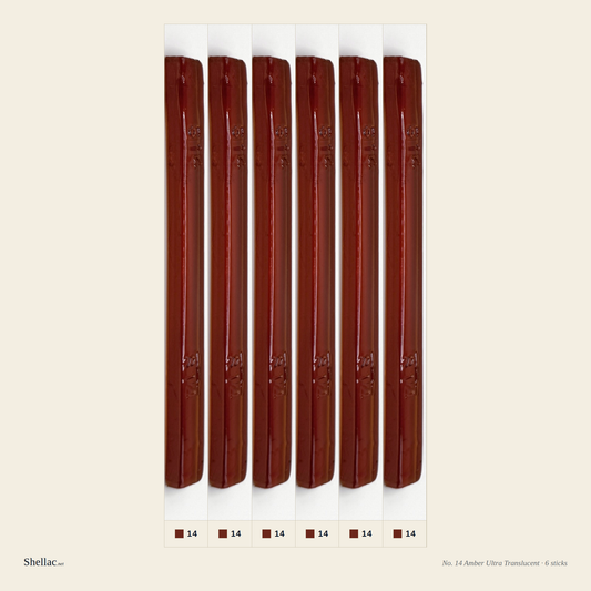 Six Merit No. 14 Amber burn-in sticks side by side — ultra-translucent warm amber, embossed color number visible