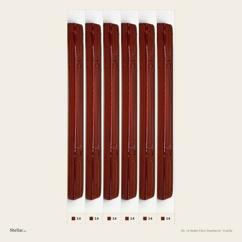 Six Merit No. 14 Amber burn-in sticks side by side — ultra-translucent warm amber, embossed color number visible