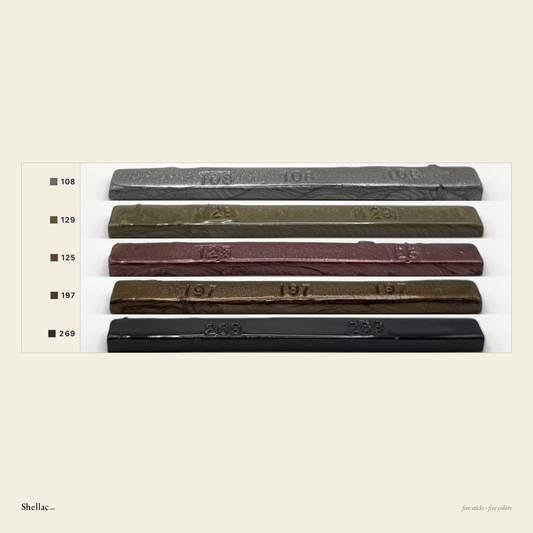 The Metallic Five color chart — five Merit burn-in stick colors, each labeled with its number, silver, taupe, copper, gold and gray